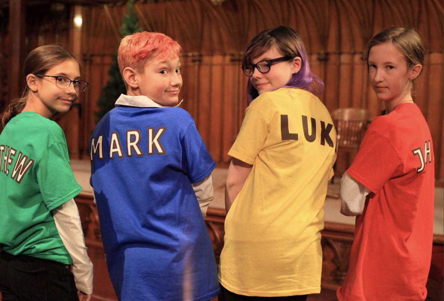 children wearing colorful Matthew, Mark, Luke and John shirts